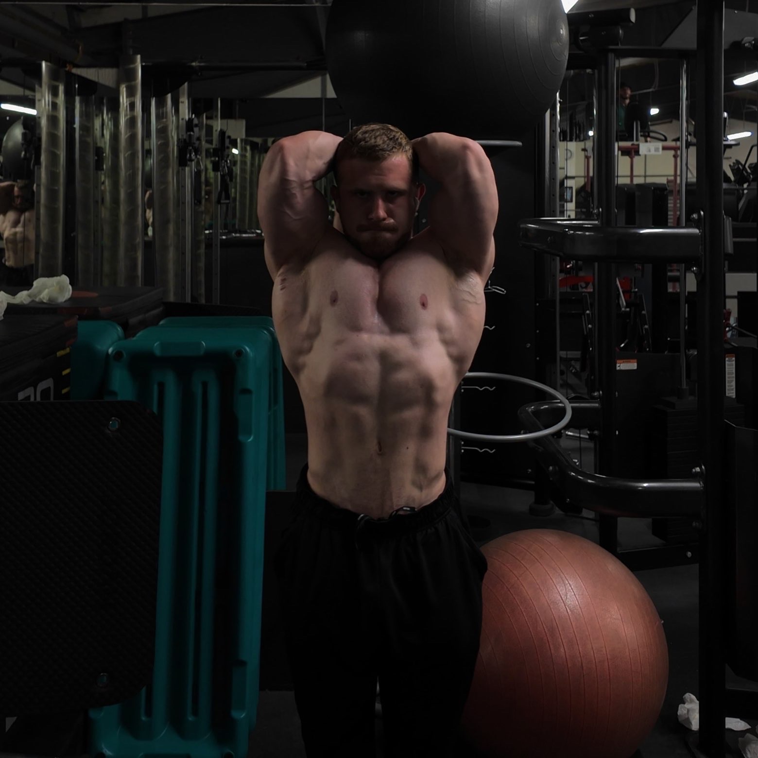 Kieran Blood with his hands behind his head, showing his abs
